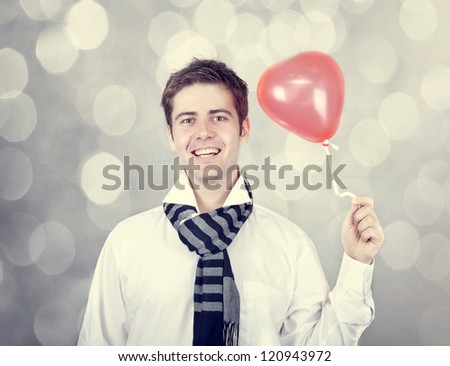 Beautiful men with heart balloon. St. Valentine