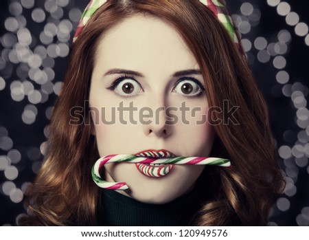 Beautiful surprised women with Christmas candy.