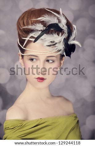 Redhead girl with Rococo hair style at vintage background. Photo in old style.