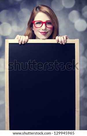 Redhead student with blackboard.