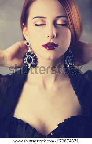 Beautiful redhead women with earrings.