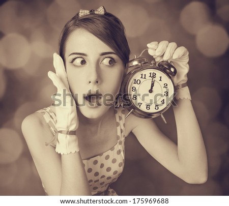 Beautifu women with clock. Photo in retro style with bokeh at background.