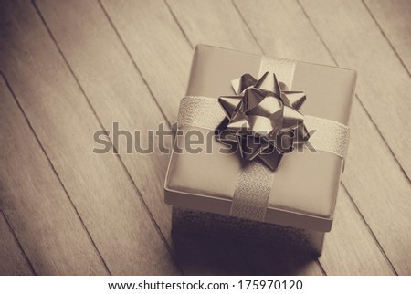 Christmas gift box on wooden table. Photo in old color image style.