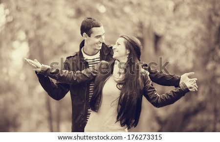 Teen couple in the park. Photo in old color image style.