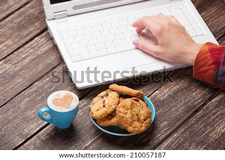 Cookie and women hand with notebook.