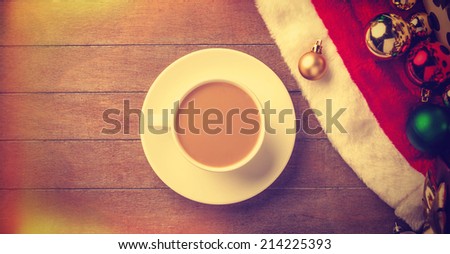 Cup of coffee and gifts at background