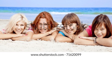 Girlfriends lying down at the beach.