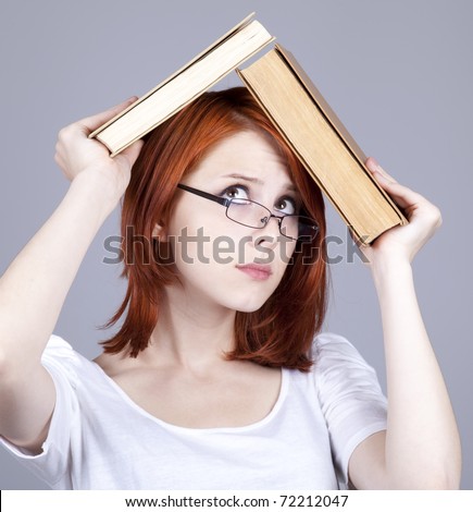 Red-haired businesswoman  keep books in hand.