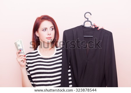 A young beautiful caucasian girl with blouse and money on pink background