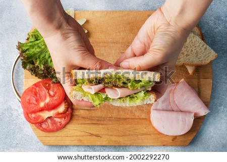 Similar – Image, Stock Photo Preparing a ham salad with rice to take away. The containers used are compostable.