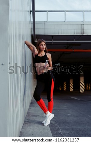 Similar – Image, Stock Photo Sportswoman leaning on wall on street and looking at camera