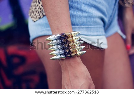 bracelet on his hand A young girl in hot pants