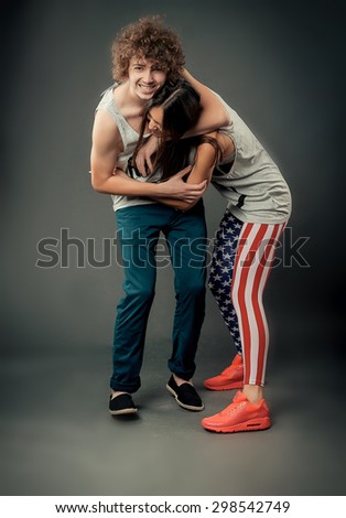 curly-haired guy with a beautiful girl studio photo fool around and have fun