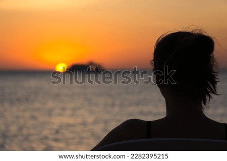Safaga - Egypt  women on the beach watching the beautiful sunrise. Silhouette of a woman on the Red Sea Zdjęcia stock © 