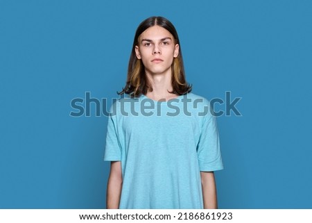 Image, Stock Photo Long haired young handsome man on a black background with a light illuminating his face, with a flirtatious expression for the camera showing a slight smile