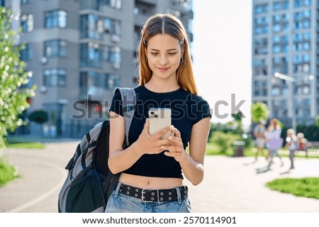 Similar – Image, Stock Photo Stylish teenagers using smartphone outdoors