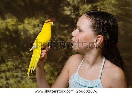brunette girl and yellow parrot