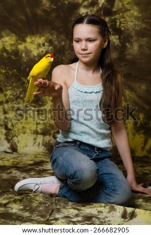 brunette girl and yellow parrot
