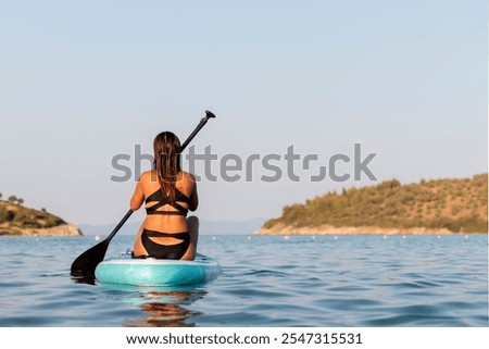 Similar – Image, Stock Photo Female surfer standing at the beach with surfboard