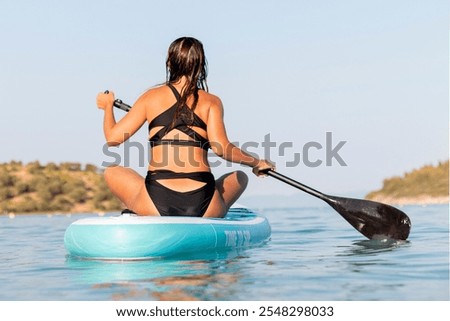 Similar – Image, Stock Photo Female surfer standing at the beach with surfboard