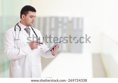 Doctor showing blank tablet pc in hospital