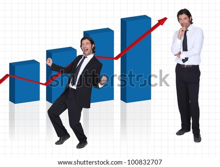 Man stood by graph of financial results