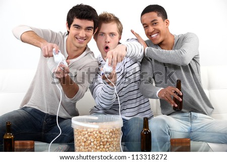 Three male teenagers playing video games.