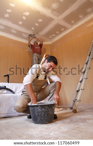 Two plasterers working on the same project