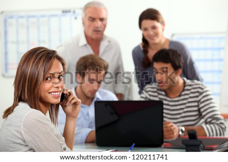woman advising a group  of people possibly a family