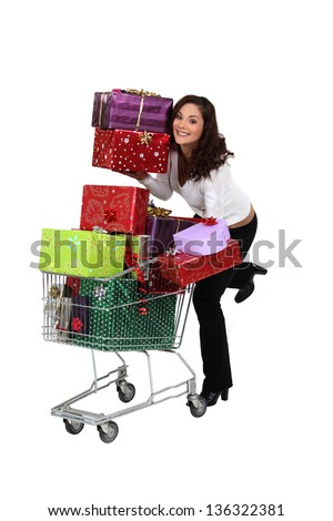 Woman pushing trolley full of presents