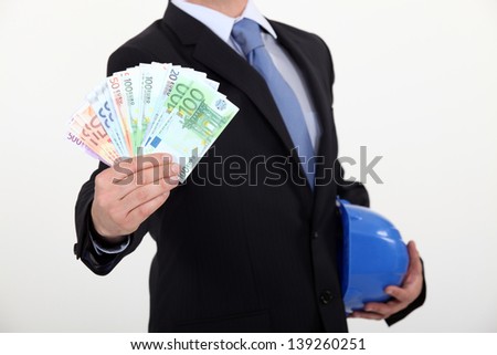 real estate businessman holding money in cash