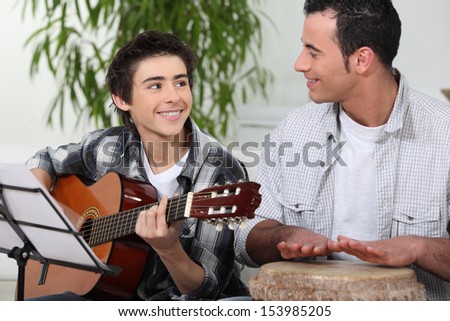Father and son playing music