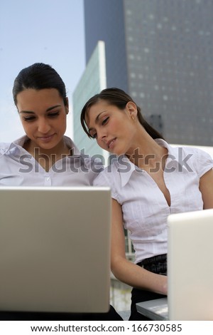 Businesswomen surfing the net outside