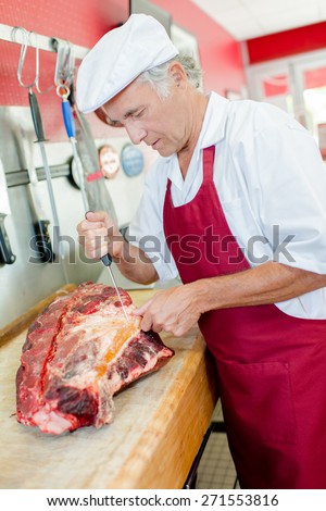 Butcher preparing a cut of meat