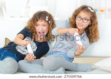 Sisters playing on a games console