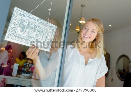 Woman with open shop sign