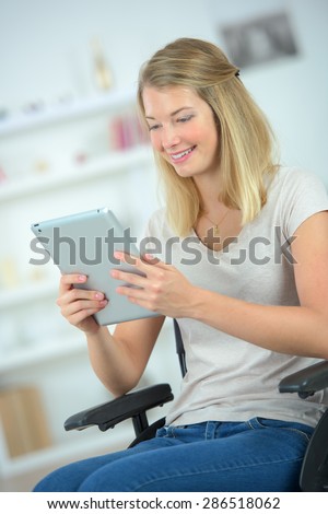 Young disabled woman using a tablet computer