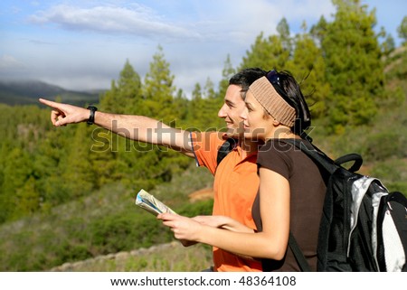 Hikers in countryside pointing at something