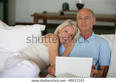 Senior couple with computer at home