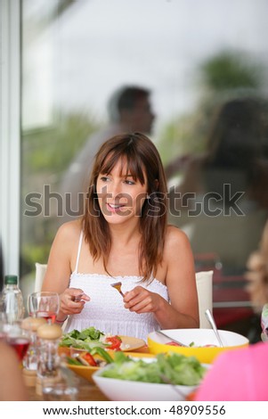 young woman having dinner with friends