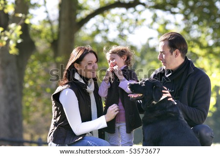 Portrait of a smiling family with a dog