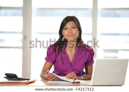 Portrait of a young woman in front of a laptop computer