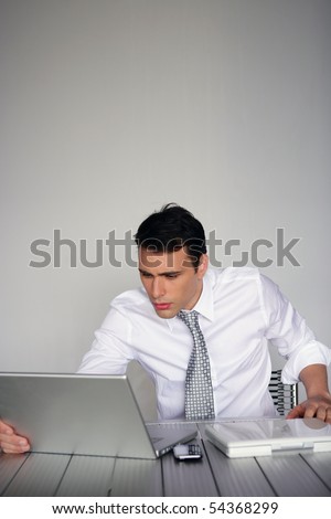 Portrait of a man in suit in front of a laptop computer