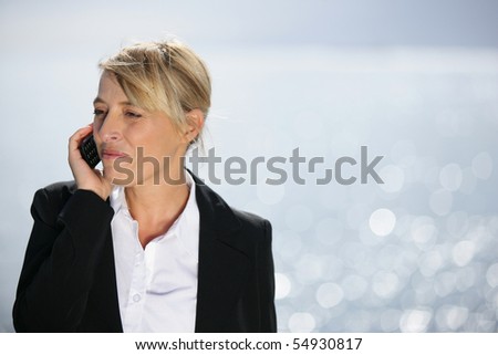 Portrait of a woman in suit phoning