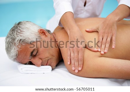 Laid man being massaged