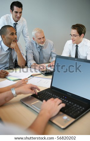 Businessmen in a meeting with a laptop computer