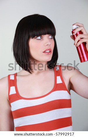 Young woman with hair spray