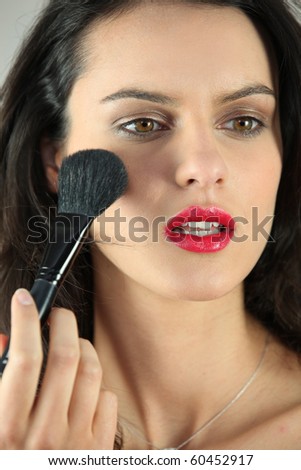 Portrait of a woman making up cheeks