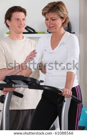 Senior woman and sports trainer