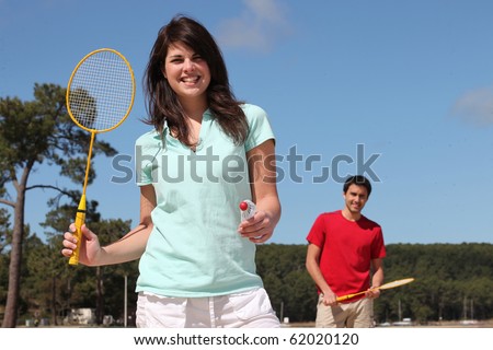Man and woman playing badminton